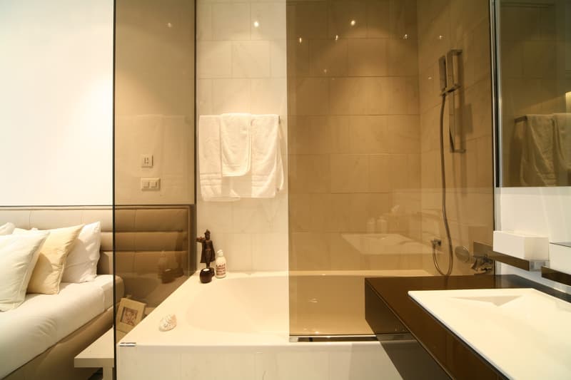 walk-in bathtub, mirror, countertop sink, shower, towels