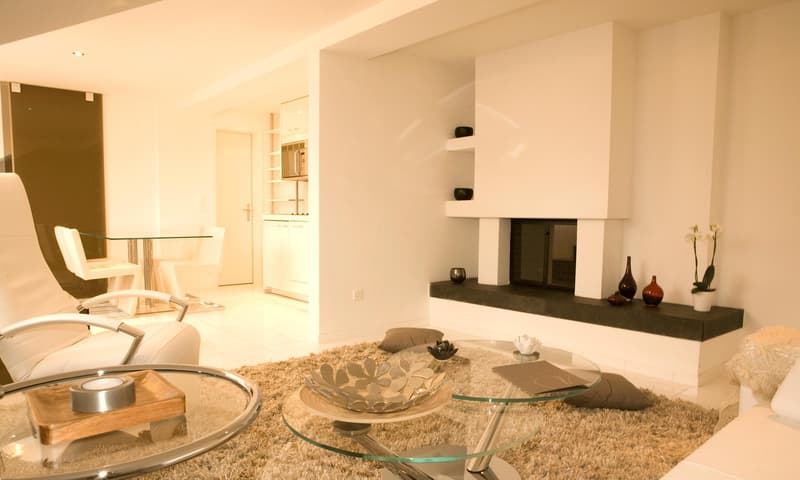 modern living room, glass tables, couches, fireplace, white walls, glass doors