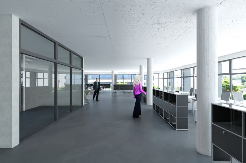 Spacious office with glass walls, columns, and furniture