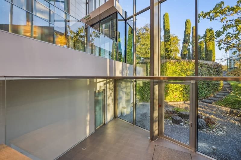 Modern building, glass walls, tiled floor, large balcony