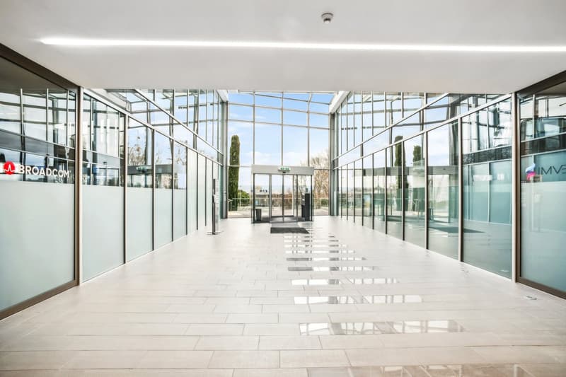 modern building, glass walls, white tiled floor, large entrance, glass doors, outdoor view
