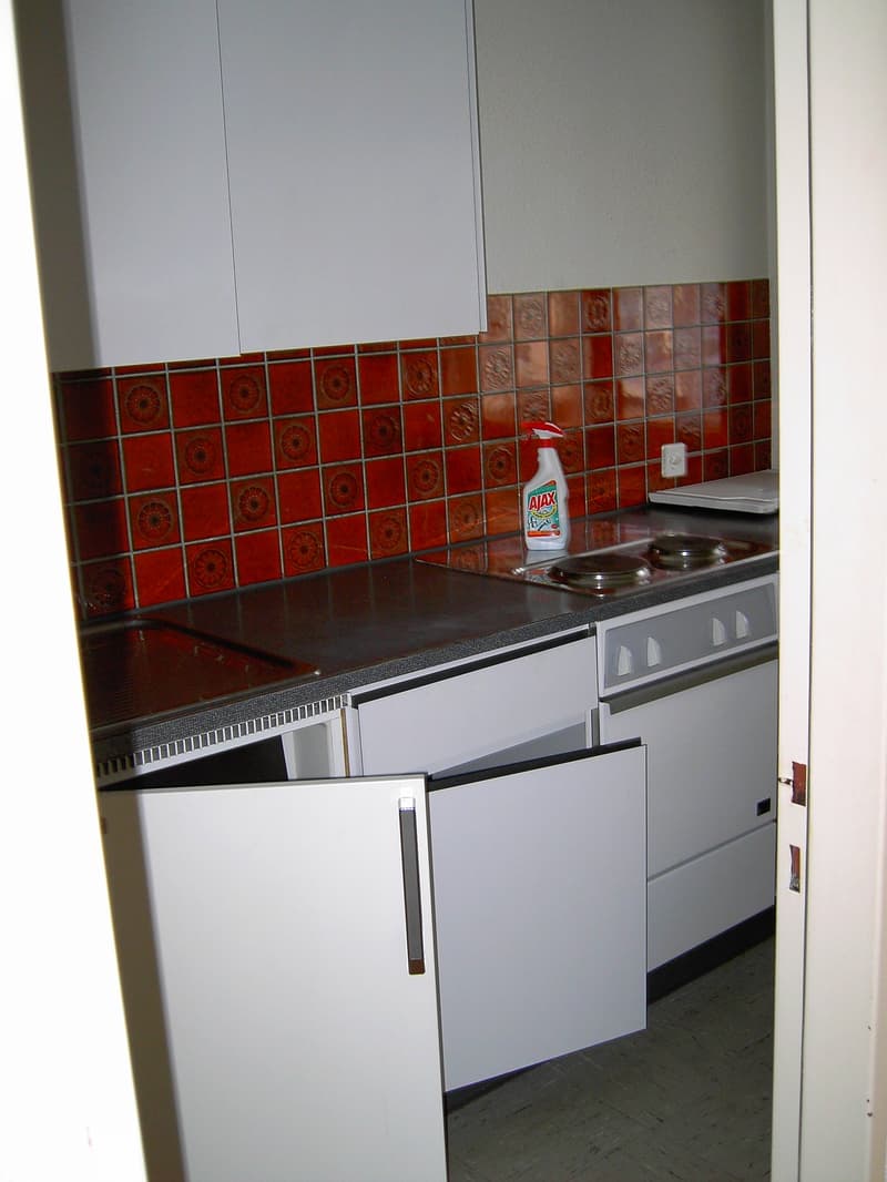 white cabinets, tiled wall, dishwasher, washing machine, stove, sink, counter