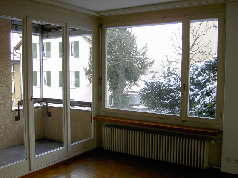 sliding glass doors, balcony, large windows, radiator, wooden floor