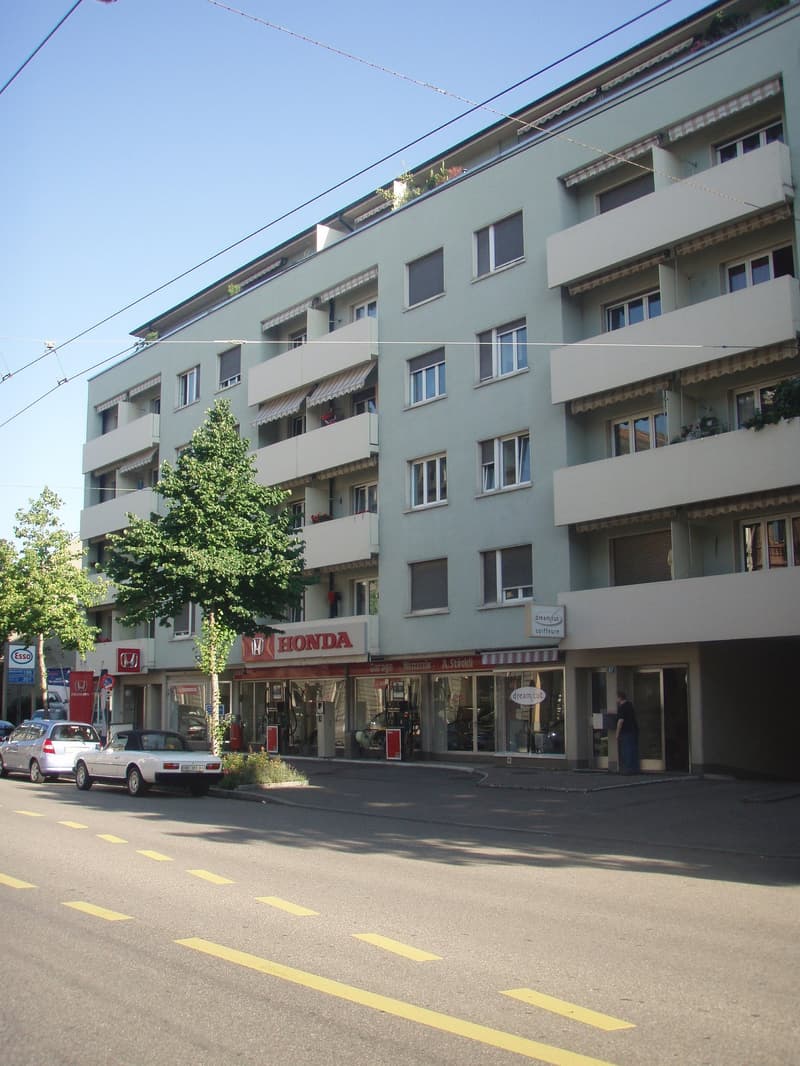 five story building, balconies, two red and white banners for honda