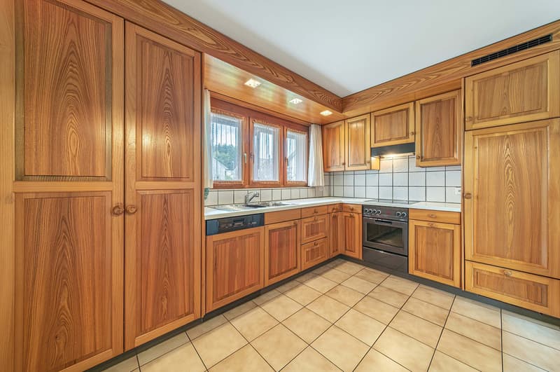 modern wooden kitchen cabinets, tiled flooring, white countertop, sink with faucet, built-in dishwasher, electric oven, and stove