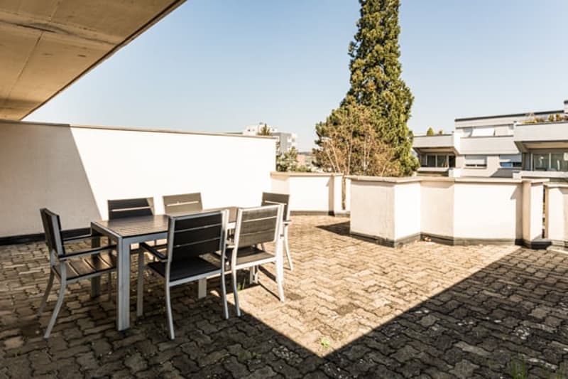 Balcony with outdoor dining table and chairs