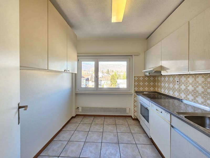 white cabinets, floor-to-ceiling windows, tiled flooring, modern kitchen design, stainless steel sink and dishwasher