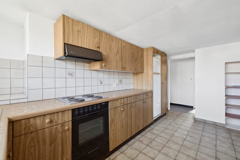 Spacious kitchen with wooden cabinets, tiled backsplash, electric stove, and a dishwasher