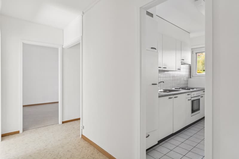 Open layout, granite countertops, double sink, built-in oven and dishwasher, tiled floor, white cabinetry, window