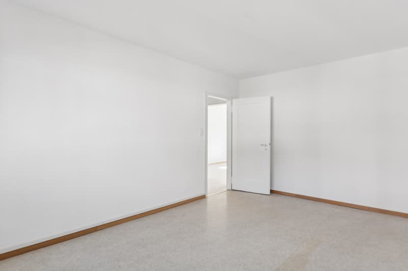 white walls, white floor, an open door