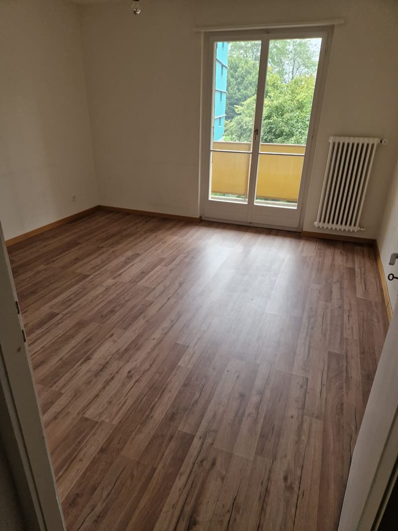 empty room, wooden floor, sliding glass door, balcony, white radiator, power outlet