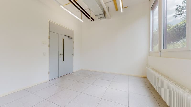 Empty room, white tiled floor, two entrance doors, white walls, large window with views, metal radiator