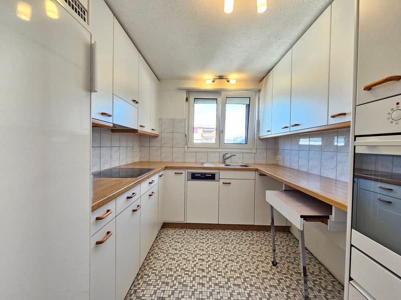 modern kitchen with white cabinets, wooden countertops, tiled floor, dishwasher, washing machine, sink, and a window