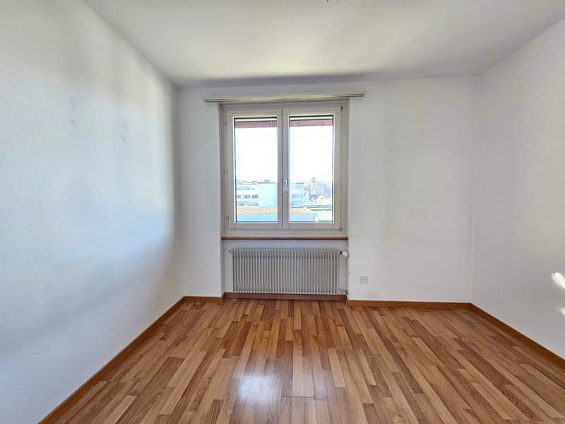 empty room, wooden floor, white walls, large window, radiator