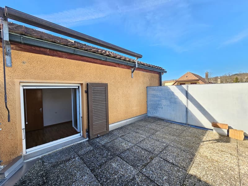 Terraced house, beige exterior, wooden door, glass door, paved terrace, white wall