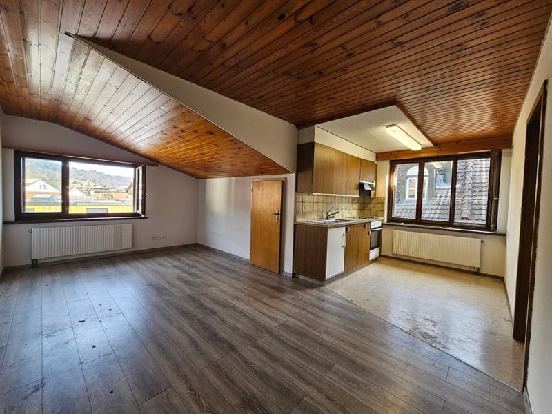 Open floor plan, wooden ceiling, wooden floor, radiator, kitchen, sink, two windows