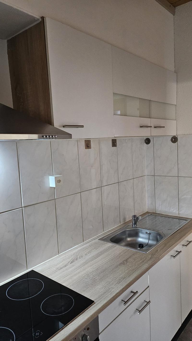 white cabinets, tile backsplash, stainless steel sink, electric stove, range hood
