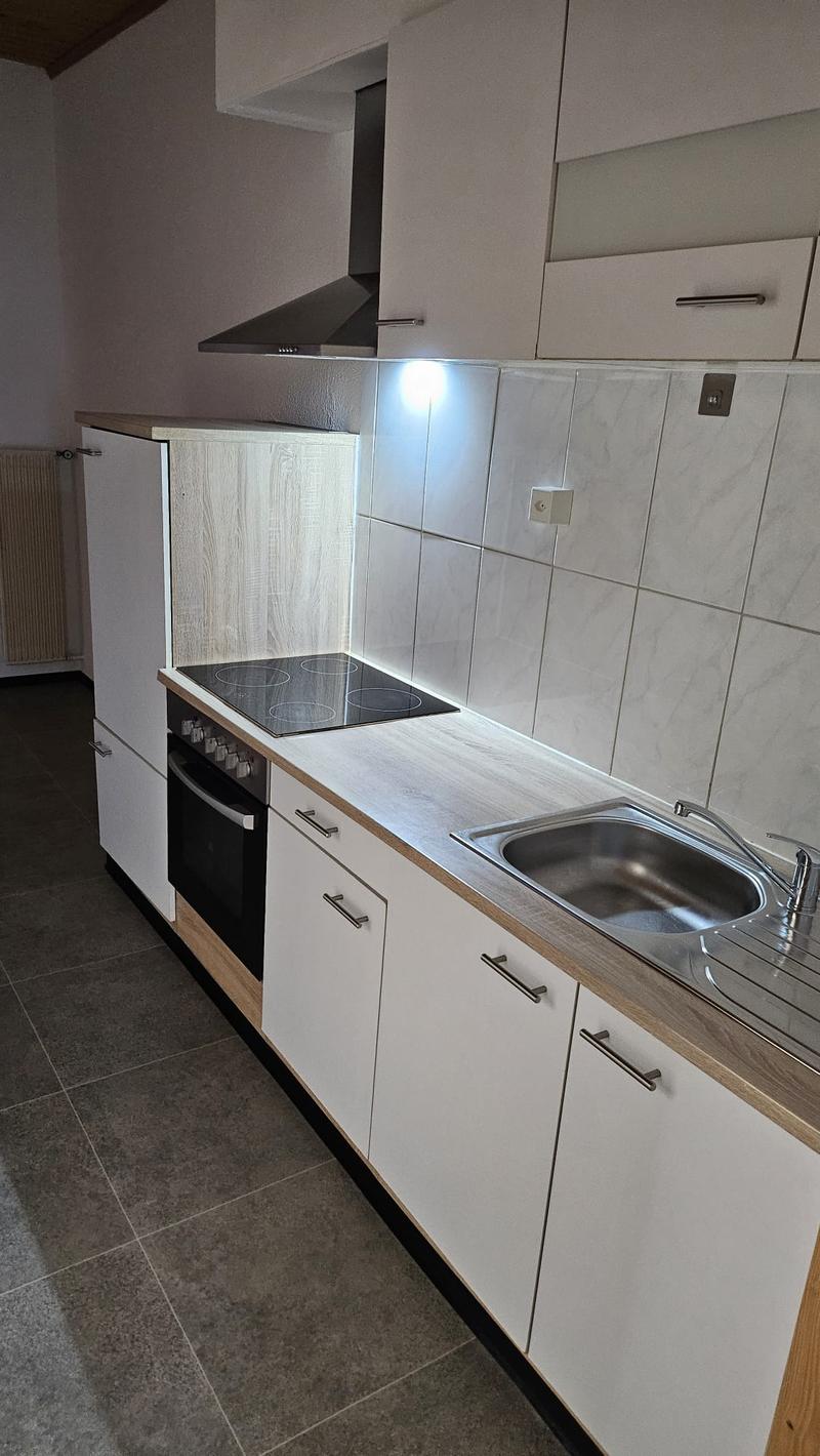 Modern Kitchen, tiled floor, white walls, gas stove, integrated dishwasher, oven, sink with faucet, tiled countertop