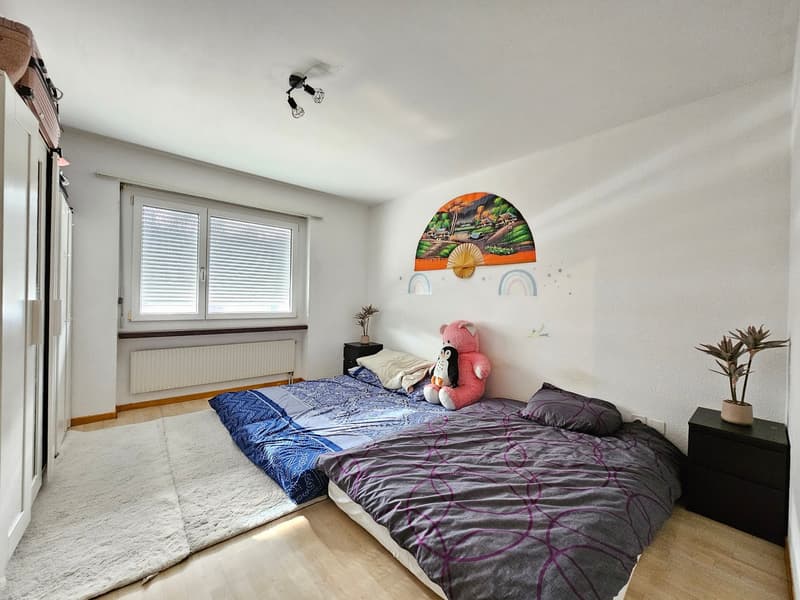 beds, pink teddy bear, plants, wall decoration, carpet, windows with blinds, heater