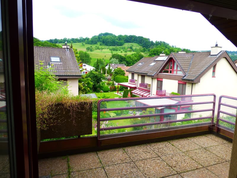 balcony with tiled floor, metal fence, view of a house and landscape