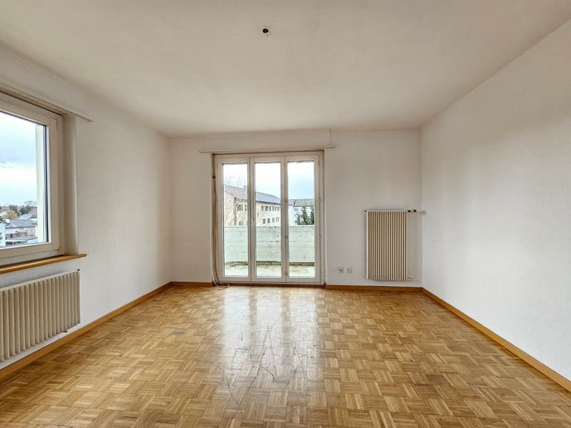 empty room, wooden floor, white walls, large windows, sliding glass doors, radiators
