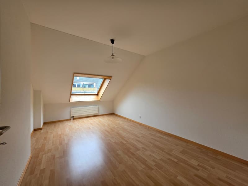 empty room, wooden floor, white walls, attic window, ceiling lamp, radiator