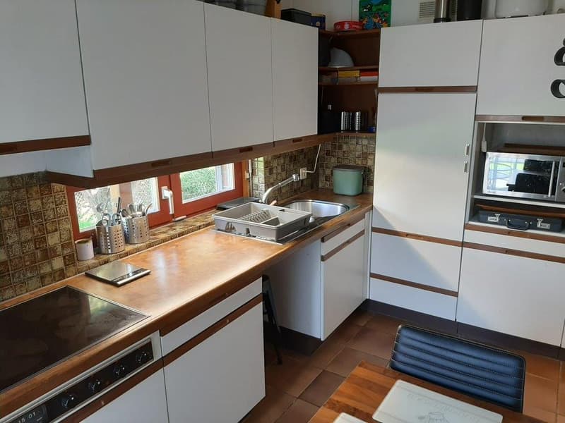 white cabinets, wooden countertops, gas stove, sink, dishwasher, microwave, tiled backsplash, window
