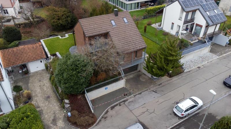 House with brown roof, garage, solar panels, driveway, car parked