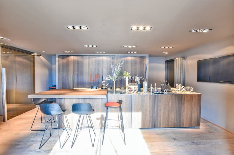 modern kitchen island, wooden flooring, cabinets, 4 bar stools, counter with appliances, kitchen utensils, plants