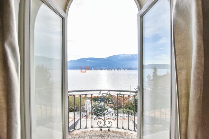 Balcony with railing, overlooking mountains and lake