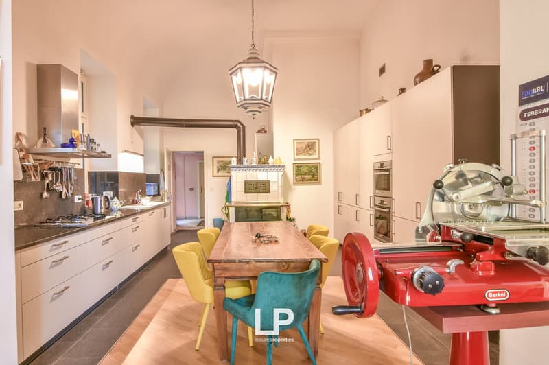 open kitchen, large window, tiled floor, dining table, hanging lamp, fireplace, oven