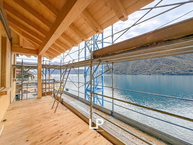 wooden ceiling, large balcony, railings, scaffoldings, lake view, mountains in background