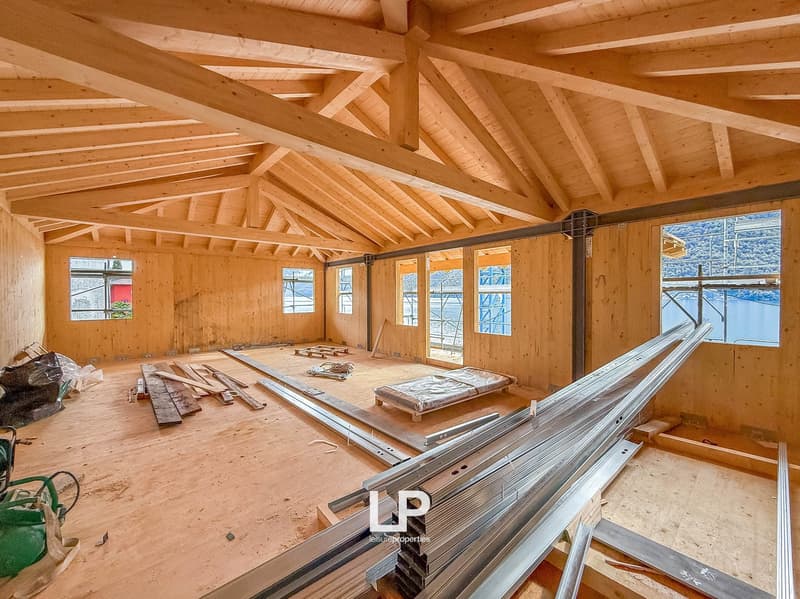 under construction, wooden walls, wooden floor, wooden beams, open area, multiple windows, unfinished