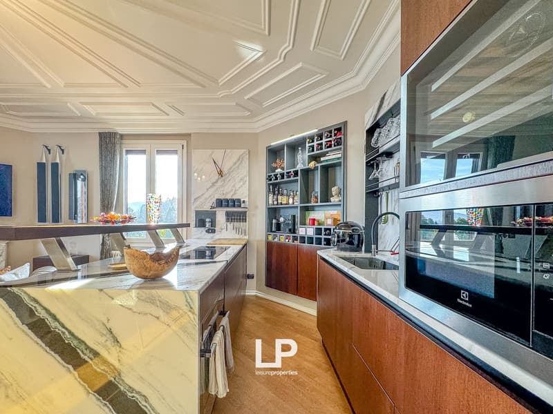 modern kitchen with marble countertops, stainless steel appliances, wooden cabinets, large windows, decorative items