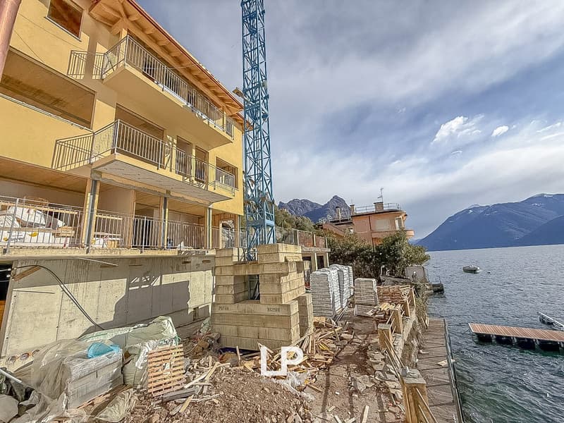 Construction site, balcony, construction materials, tower crane, water body, mountains