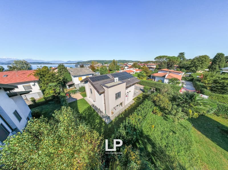 2 story house, brown roof, solar panels, large garden, nearby lake