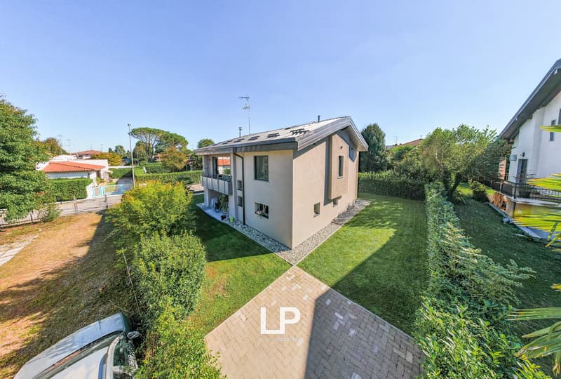Two-story house, terrace, solar panels, driveway, swimming pool, garden