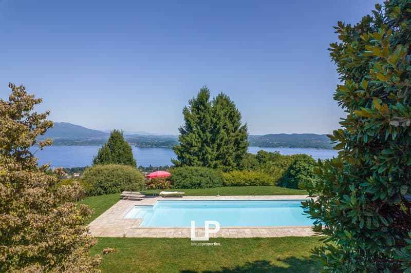 swimming pool, green lawn, trees, sun loungers, red umbrella, panoramic lake view