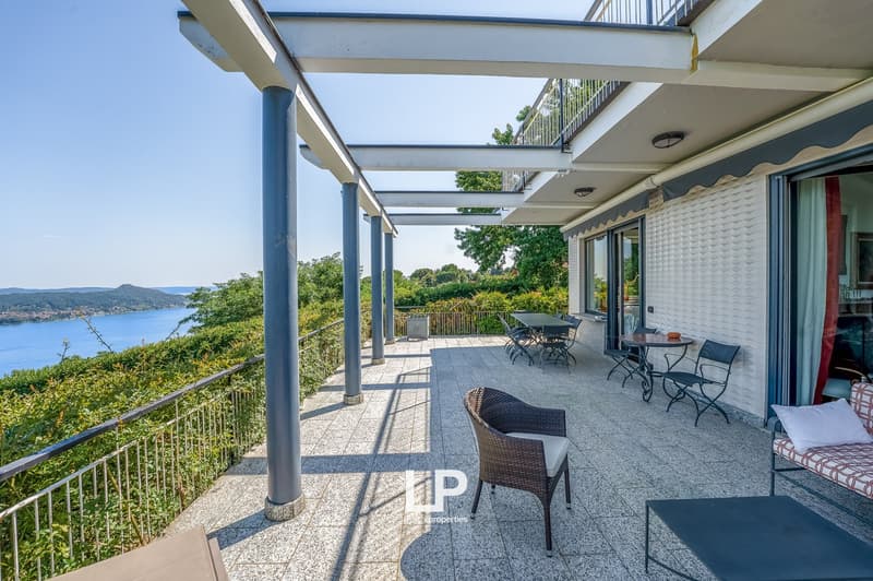 covered terrace with tables and chairs, lake view
