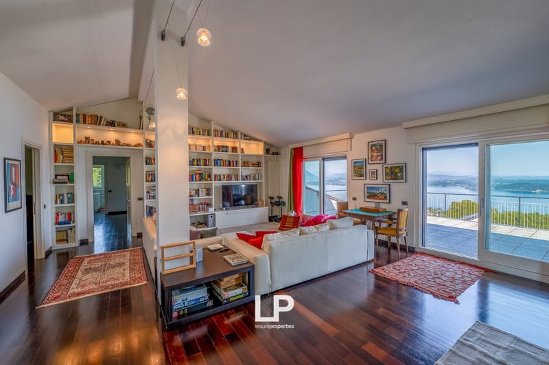 modern living room, hardwood floors, white furniture, wall-mounted bookshelves, sliding glass doors, balcony, panoramic views