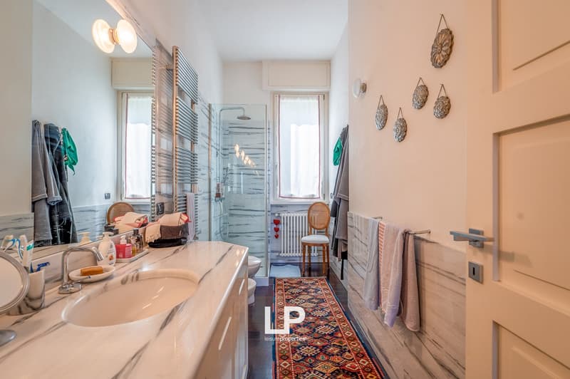 white sink, mirror, chair, toilet, shower