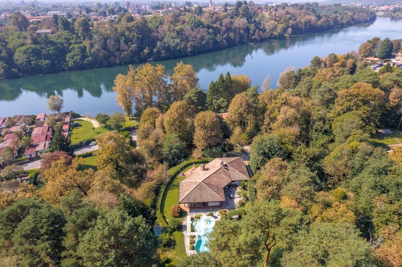 Villa with swimming pool, near river, surrounded by trees, garden
