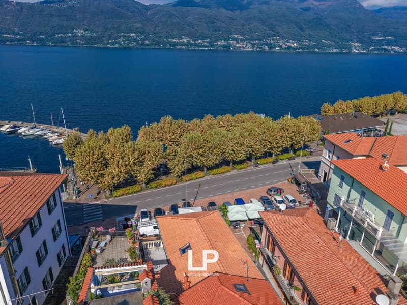 aerical view of buildings and waterfront with mountains in the background