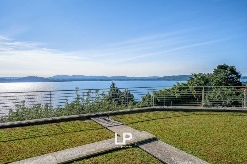 balcony with railing overlooking lake and mountains