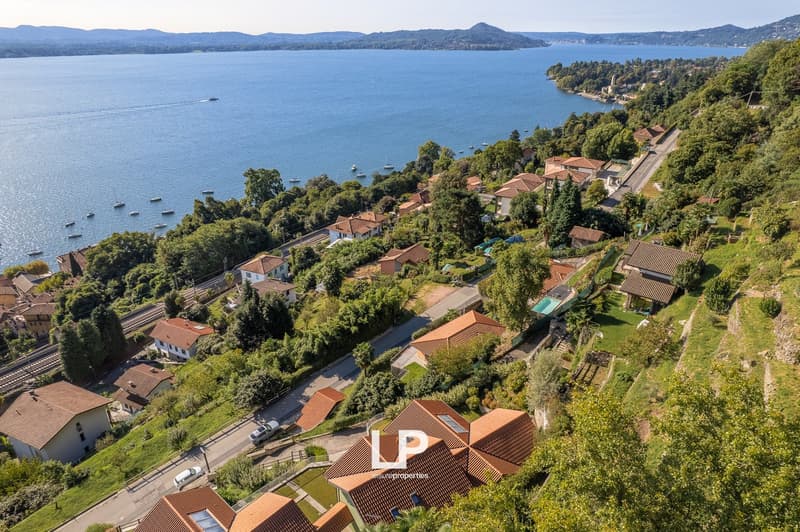 cluster of houses by the lake with mountainous background
