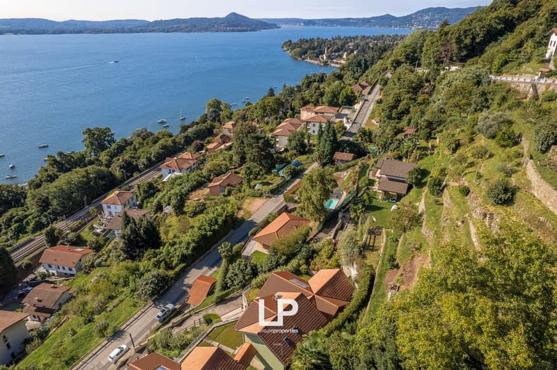 Several villas situated on a hillside with views of the lake