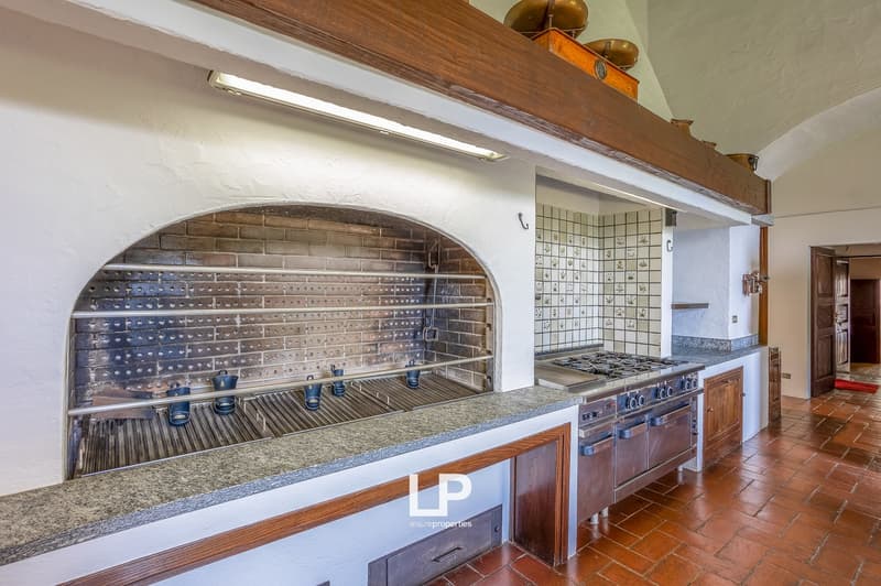 kitchen with oven, fireplace, gas stove, wooden floor