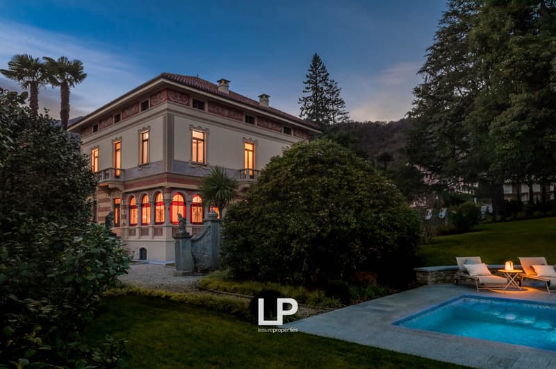 Large classical villa, 2 story, beige painted facade, large windows, swimming pool in front