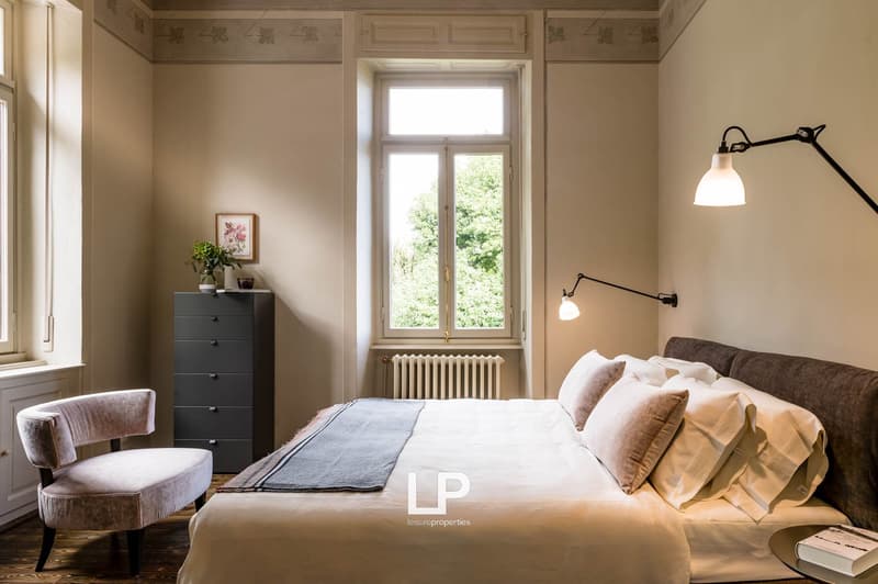 Double bed, bedside table, chair, wardrobe, radiator, window, framed picture, floor lamp, watermark