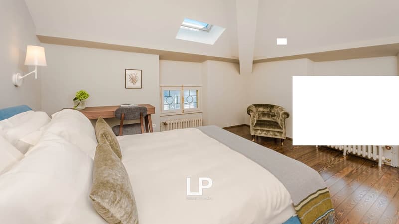 large bed, desk, chair, radiator, skylight, wall mounted lamp, picture, flower vase, pillows